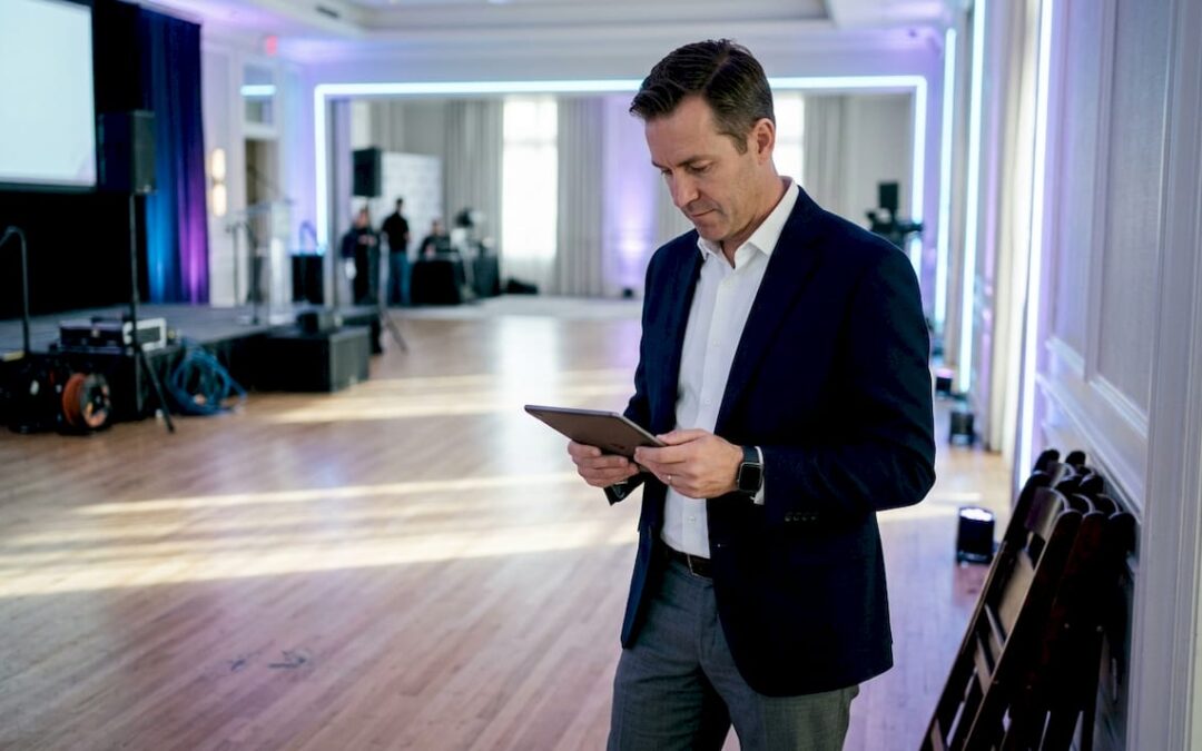 Event planner checks digital guest list in ballroom
