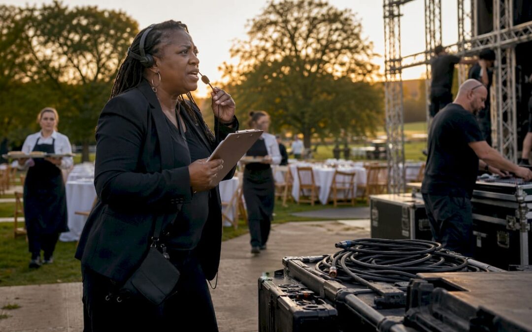Event manager coordinating suppliers outdoors