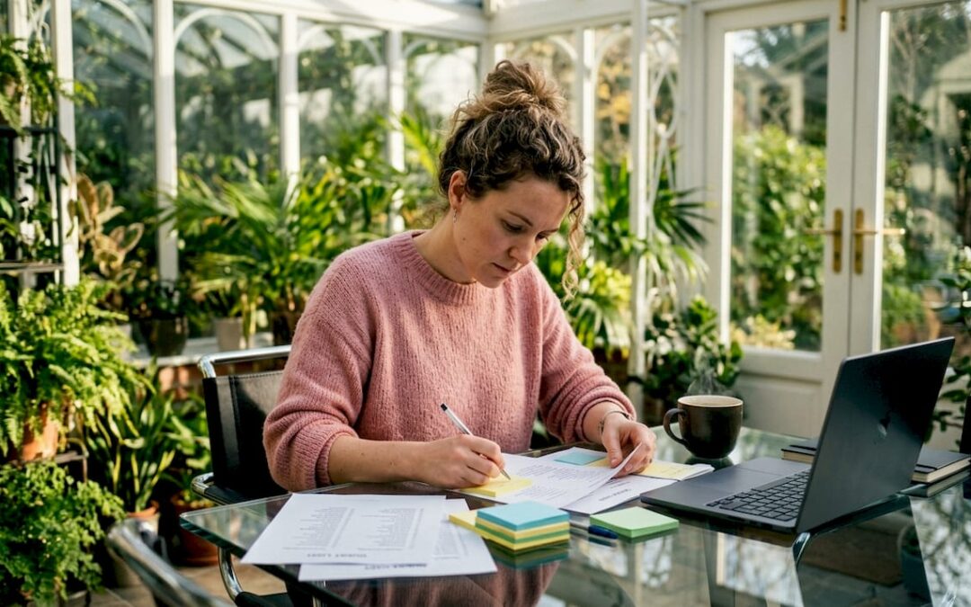 Woman organizing guest list at home office table