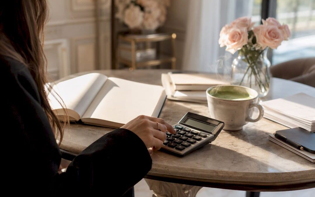 Calculator and coffee cup on wedding planning table