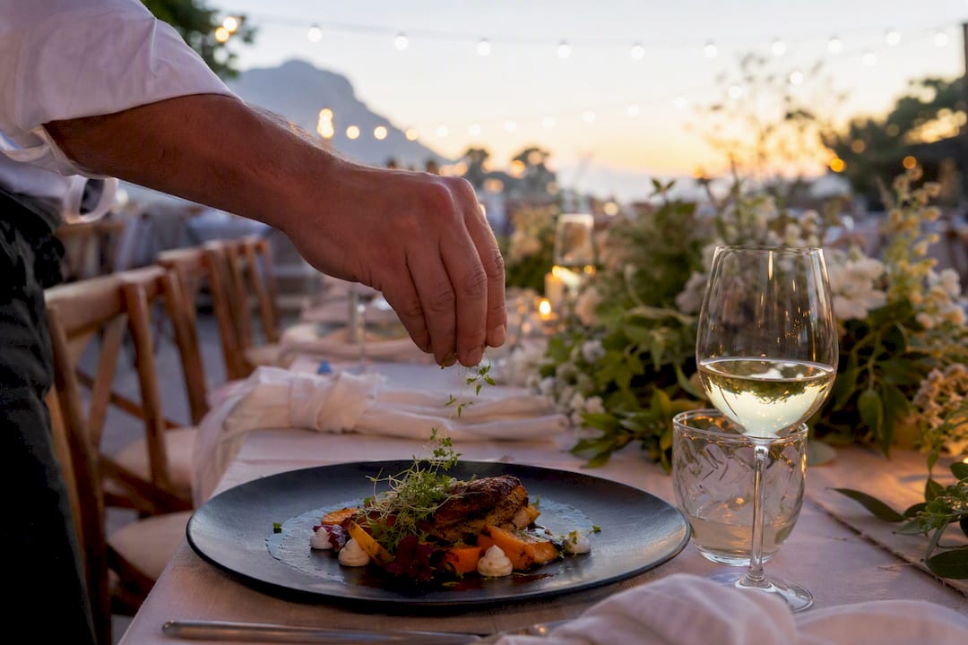 Hand plating gourmet wedding dish