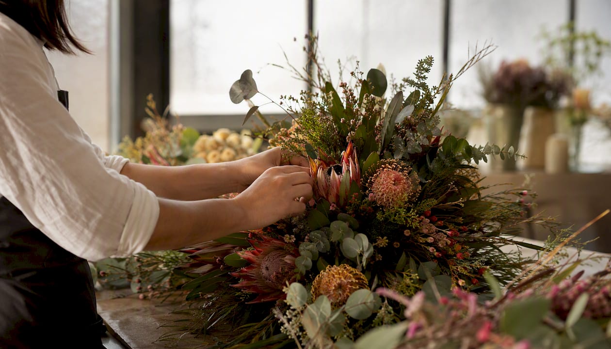 Florist arranging native flowers in luxurious Cape Town venue