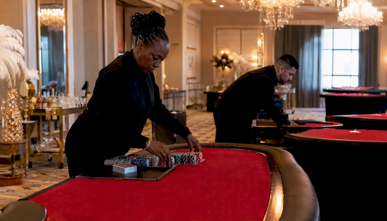 Staff setting up casino party tables