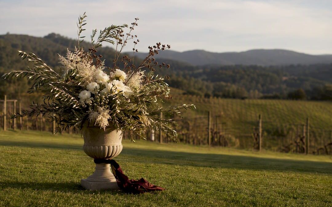 Sculptural floral urn at vineyard ceremony