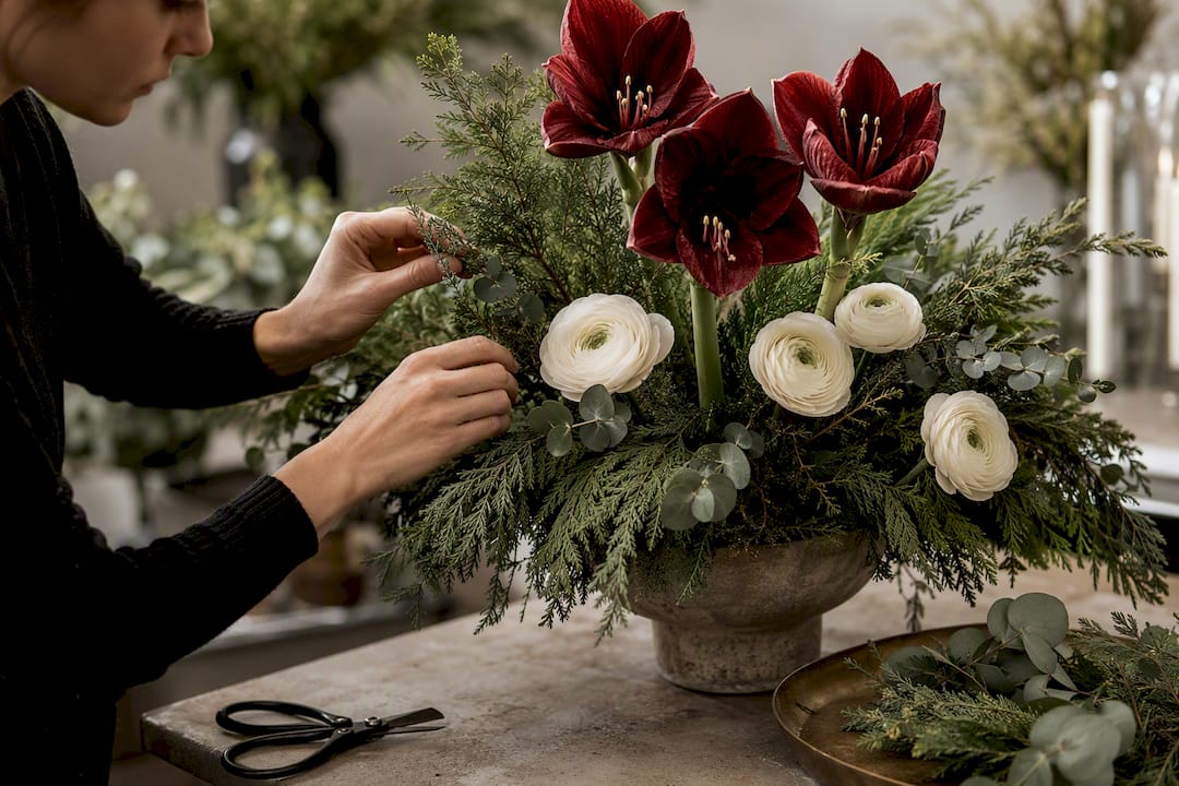 Florist arranging winter flowers and greenery
